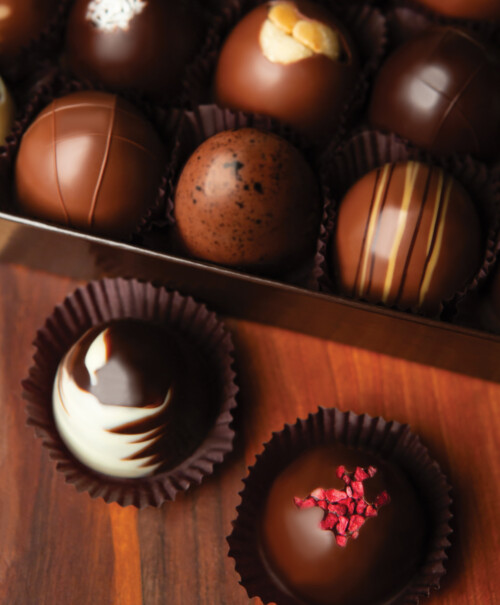 DeBrand 24 piece Truffle Collection box on a cutting board